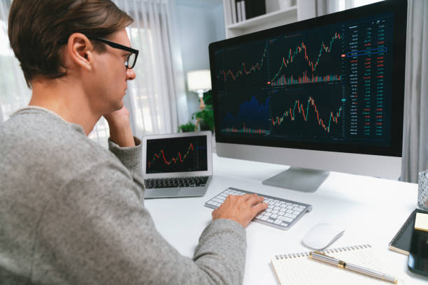 istock Business trader using computer and laptop to search high profit. Pecuniary. 1981035656