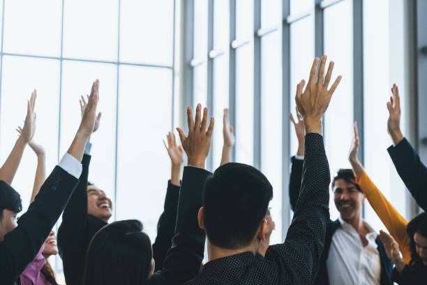 istock Successful business people raised their hands up for voting. Intellectual. 1981050554