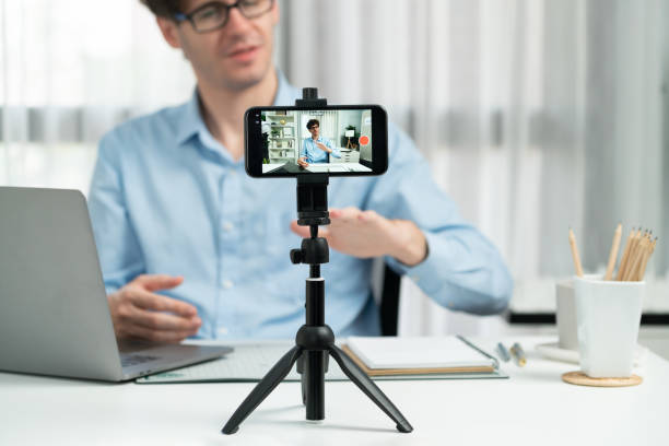 istock Influencer using phone streaming online focusing phone with portrait. Gusher. 1981101774