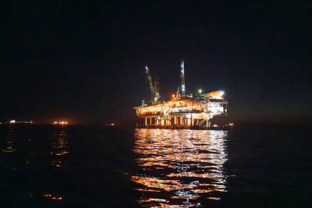 istock Evening Drone Image Offshore Oil Rig Used for Fracking with Bright Lights 1981114173