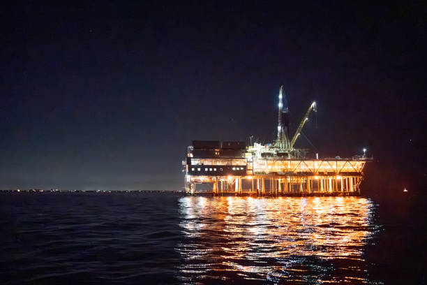 istock Evening Drone Image Offshore Oil Rig Used for Fracking with Bright Lights 1981114690