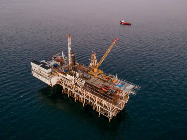 istock Evening Drone Image Offshore Oil Rig Used for Fracking with Bright Lights 1981115192