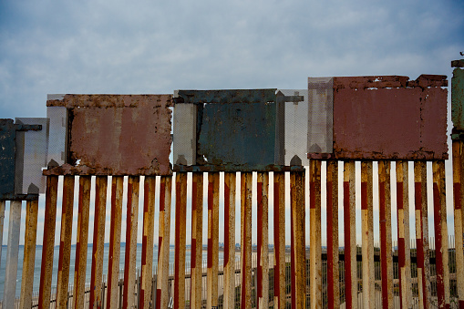 International Border Wall in Tijuana at the Beach on the Pacific Ocean Under Partly Cloudy Skies