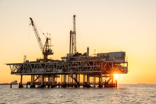 istock Evening Drone Image Offshore Oil Rig Used for Fracking with Bright Lights 1981117780