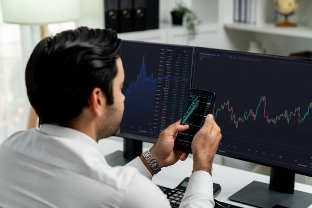 istock Trader businessman searching on smartphone, analyzing in dynamic stock. Surmise. 1981182306