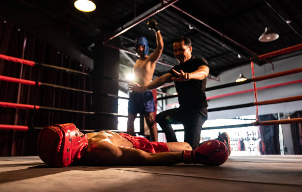 istock Referee pause action for boxer fighter's safety with winner in backdrop. Impetus 1981183907