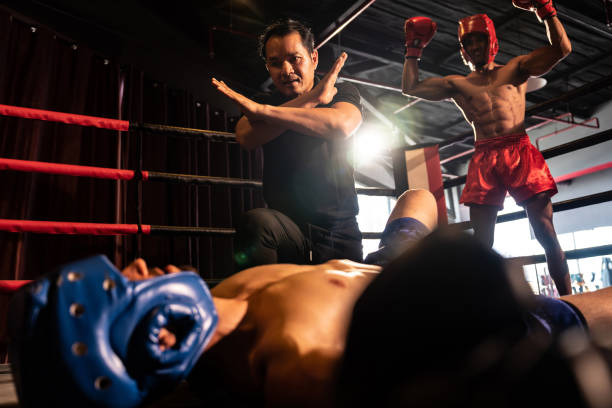 istock Referee pause action for boxer fighter's safety with winner in backdrop. Impetus 1981225087