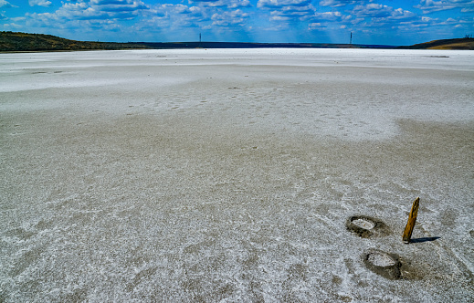 The flat bottom of the dried-up Kuyalnitsky estuary, covered with a layer of white self-precipitating common salt