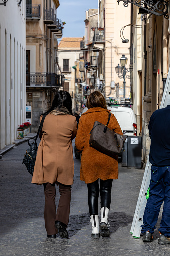 Cefalu, Sicily, Italy Jan 14, 2024 Two stylish women walking in the historical center,
