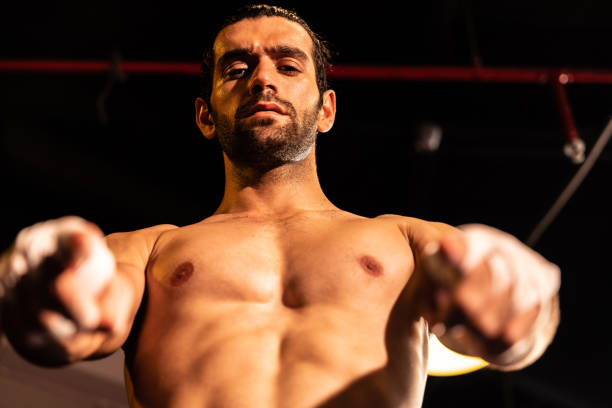 istock Caucasian boxer punch his bare fist and wrap posing. Impetus 1981281121
