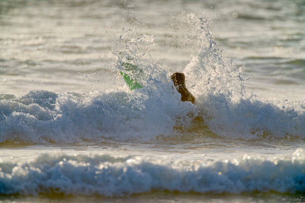 The Pacific Rim National Park on Vancouver Island on April  27, 2023: Male engaged in surfing at Pacific Rim National Park on Vancouver Island, British Columbia