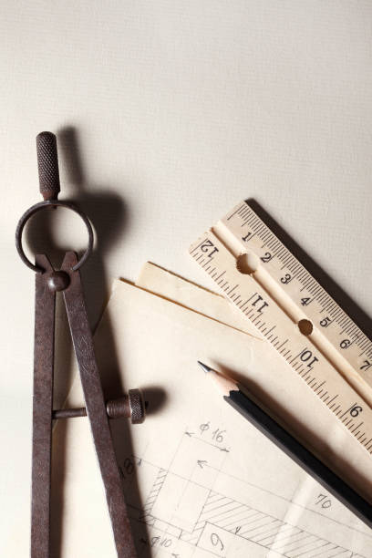 Carpenter's compass, wooden ruler, pencil and old blueprint with copy space
