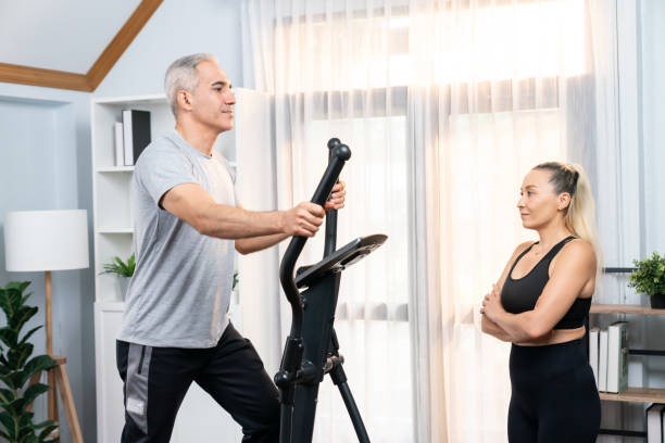 istock Active senior couple running on elliptical running machine. Clout 1981332391