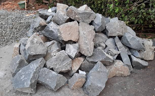 istock Large piles of river stones or split stones to make building foundations. Building materials. 1981365662