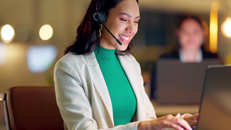Call center, computer and woman consulting at night in office for customer service, CRM advisory and sales. Happy virtual assistant laugh at laptop for telecom support, communication or telemarketing