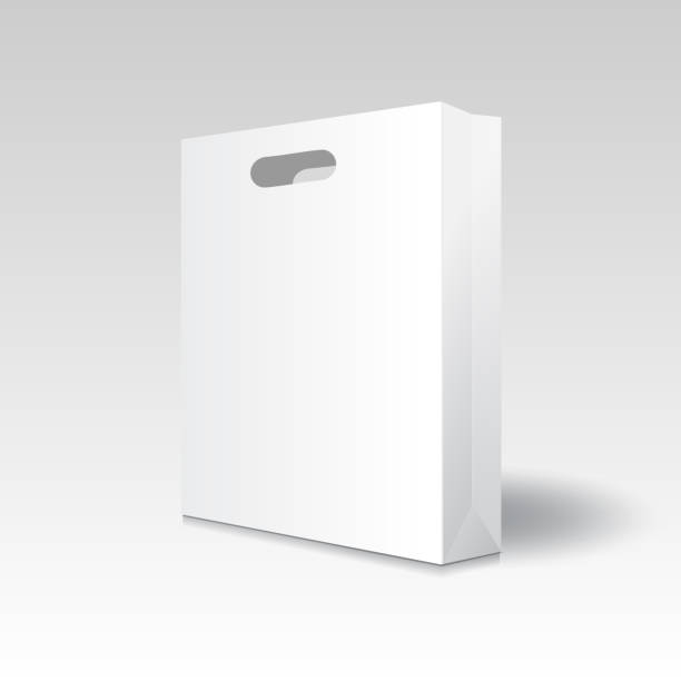 istock Blank white paper shopping bag or gift bag with punch hole handles mockup template. Isolated on gradient grey  background with shadow. Ready to use for branding design. Realistic vector illustration. 1981419626