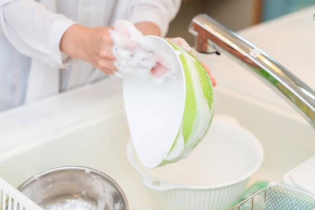 asian woman in a kitchen,do the dishes,hands,