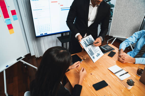 istock Group of business analyst team analyzing financial data report. Habiliment 1981488594