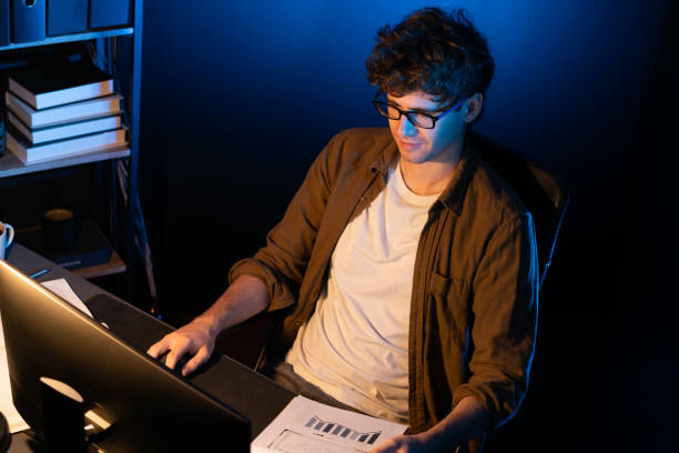 istock Young businessman reading design thinking on paper for new project. Gusher. 1981490688