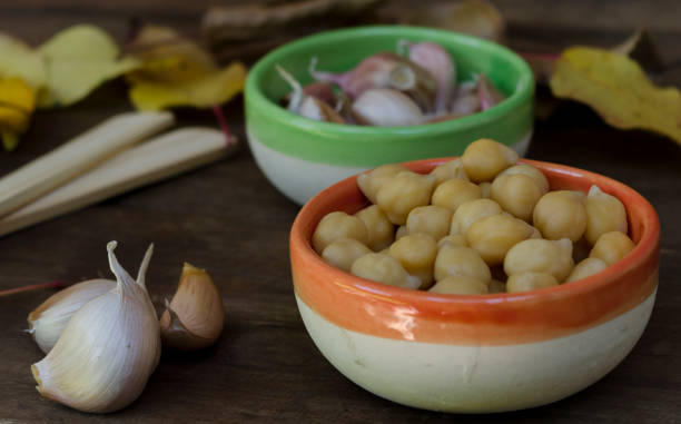 istock chickpeas and garlic on rustic table with leaves background 1981546522