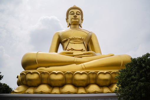 Statue of Buddha at peace on white background