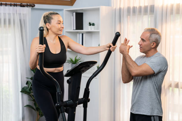 istock Active senior couple running on elliptical running machine. Clout 1981558739