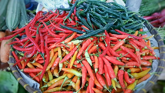 Various types of chillies in bamboo winnowing at traditional markets.