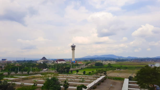 istock View around the lotus viewing tower Purwokerto, Central Java, Indonesia with several buildings and green open land with hills in the background and cloudy sky. Aerial view of purwokerto city icon 1981590257