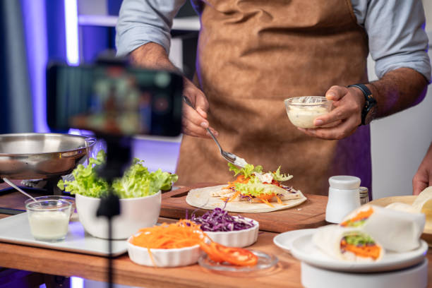 Cropped view of chef influencers presenting fresh salad roll. Sellable.
