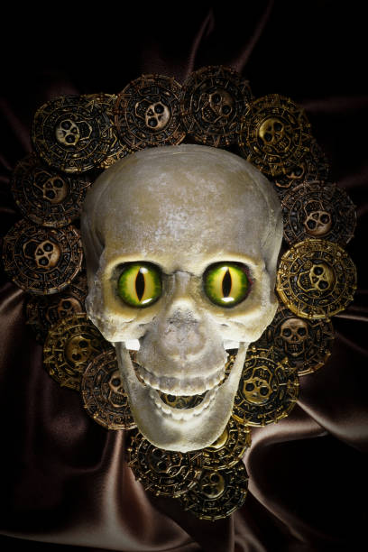 homemade scary skulls with menacing eyes and pirate treasure coins background - bronze rubber plastic metal zdjęcia i obrazy z banku zdjęć