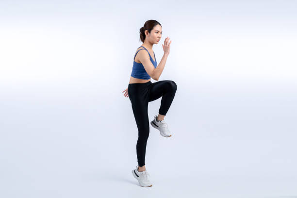 istock Side view young athletic asian woman on running posture. Vigorous 1981767080