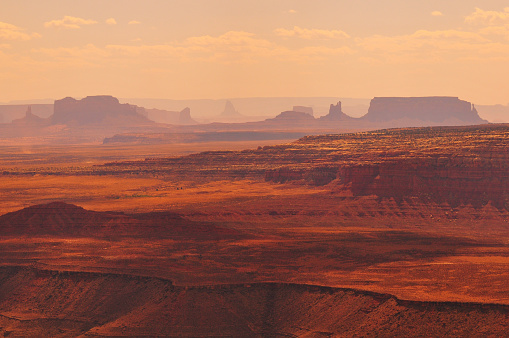 Spectacular afternoon view of the Goosenecks of the San Juan river and the distant buttes and mesas of Monument Valley from Muley Point viewpoint, Utah, Southwest USA.