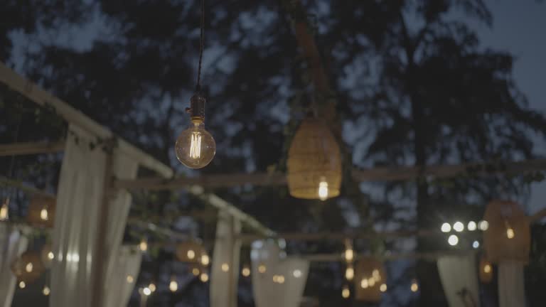 Wedding event hanging set up light romantic dinner.