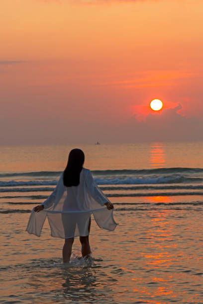 istock Woman pretty with bikini and silhouette on beach 1981824579