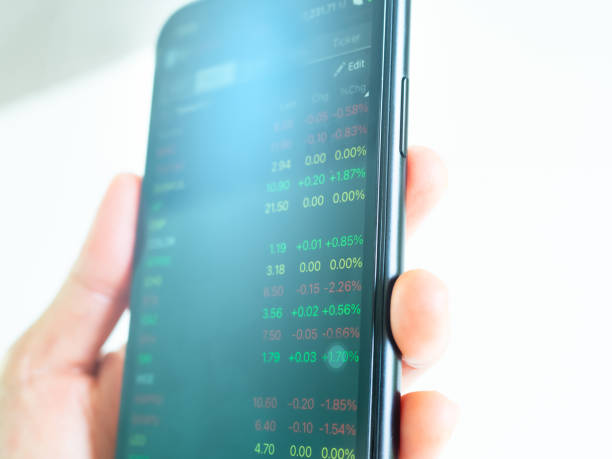 istock Stock Market Trade App Holding Smartphone 1981866310