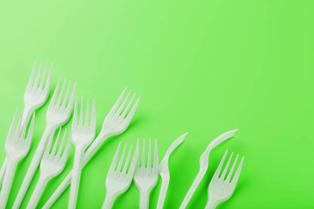istock Plastic dishes on a green background with free space. 1981868429