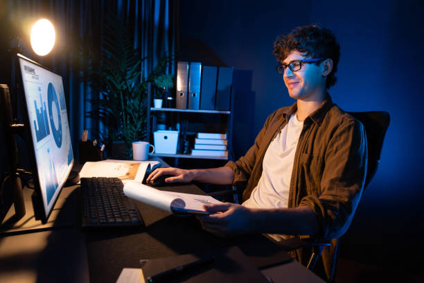 istock Young businessman reading design thinking on paper for new project. Gusher. 1981922041