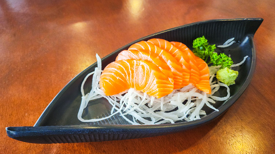 Raw salmon sashimi pieces, premium Japanese food object photo, close-up and selective focus.