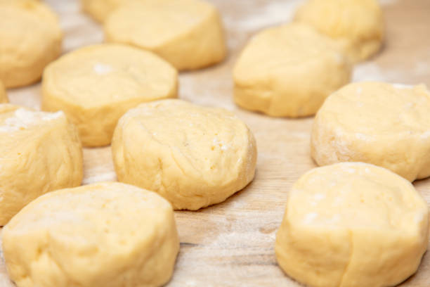 istock Pieces of dough on the table in flour. 1981939771