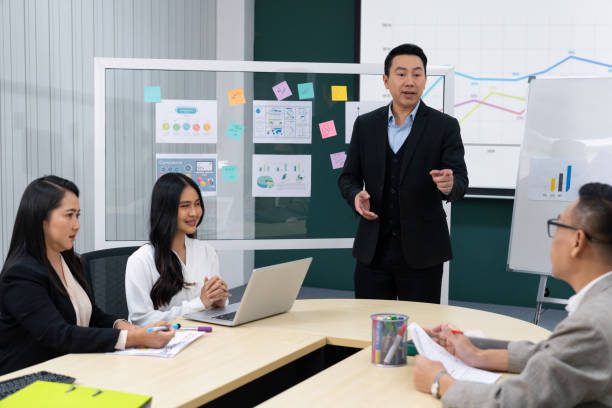 istock Businessmen present financial project for managers' approval. Intellectual. 1981948178