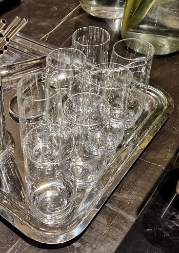 Jakarta, Indonesia - Feb 01, 2024: Clean transparent glasses put on a silver tray