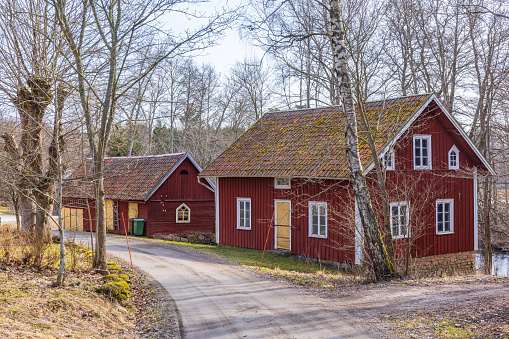 Falköping, Sweden-Marsh, 2022: Old buildings by a gravel road in the countryside