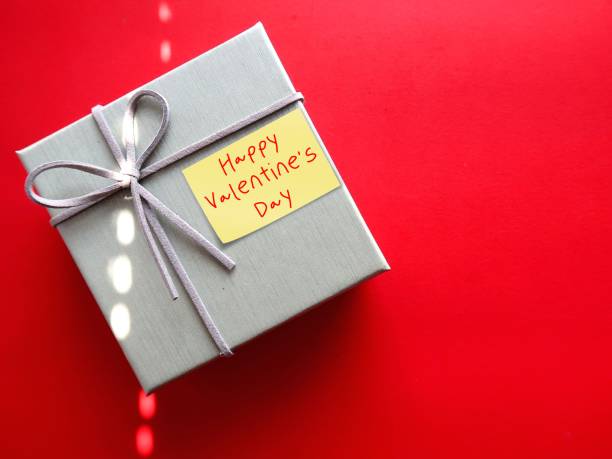 istock Gift box on red copy space baclground with handwritten text HAPPY VALENTINE 'S DAY, concept of express romantic love and make someone feel special on Valentines's day 1982002220