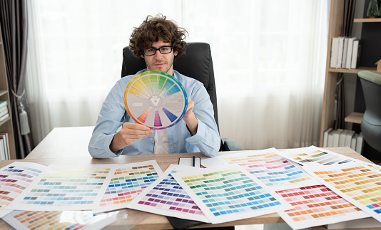 Caucasian businessman working with color chart at office