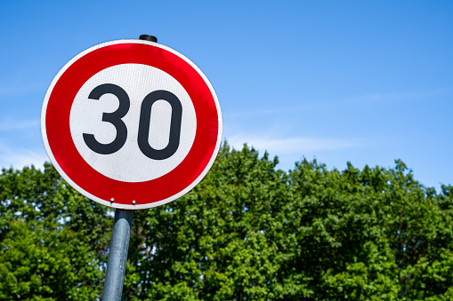 Speed sign with number 30 kilometer per hour in the countryside