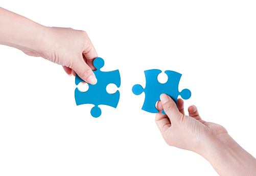 Two Puzzle Pieces Coming Together isolated on white background