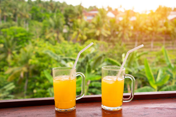 Fresh fruit juice in cafe overlooking tropical forest on Bali island in Indonesia