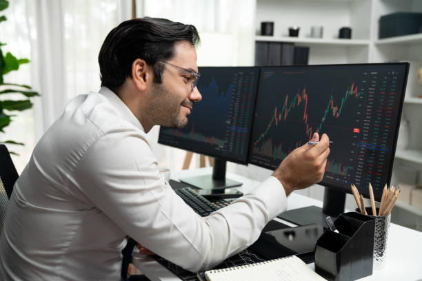 istock Trader analyzing in dynamic stock exchange investment screen on pc. Surmise. 1982144471