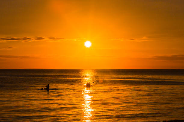 vietnam:  sunset  on island Phú Quốc. Looking over the  Gulf of Thailand. Passing by a small boat.