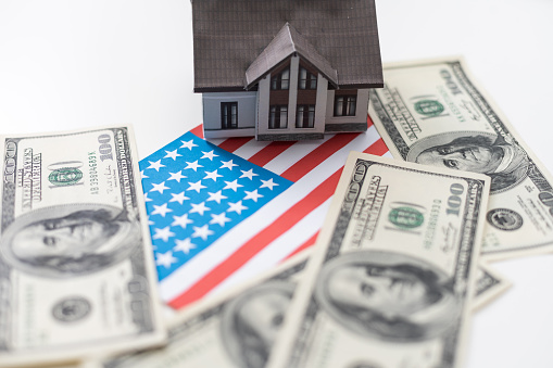 House symbol on American flag. Mortgage credit lending. Housing safety. High quality photo